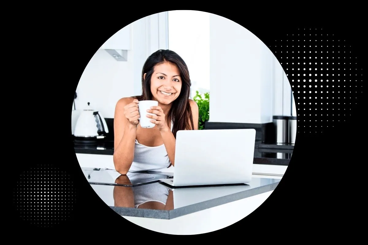 woman in kitchen smilling and drinking coffee