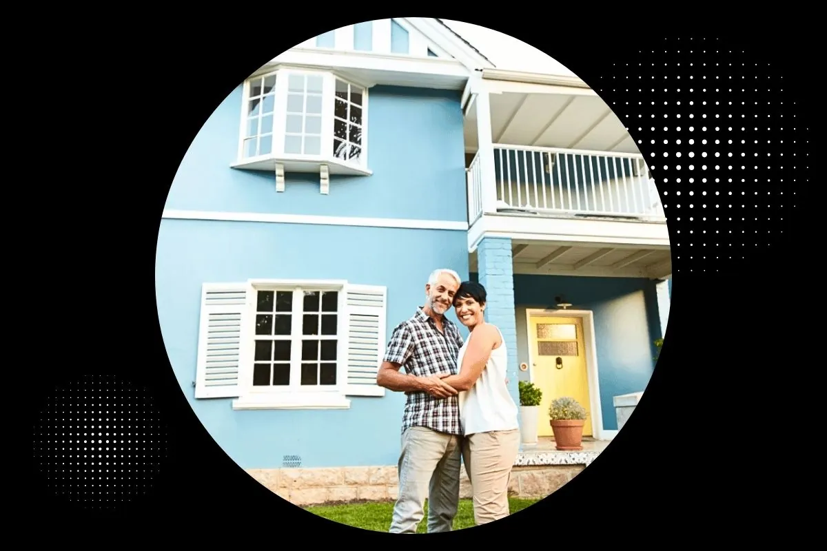 mature couple standing outside beautiful house